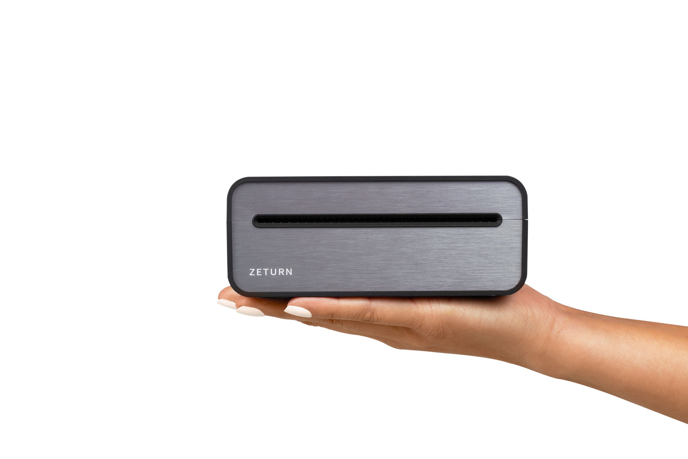 The Zeturn Tiny Printer resting on an open palm